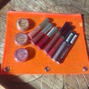 Variety of Lip Glosses in all shades in a neon orange plastic pouch